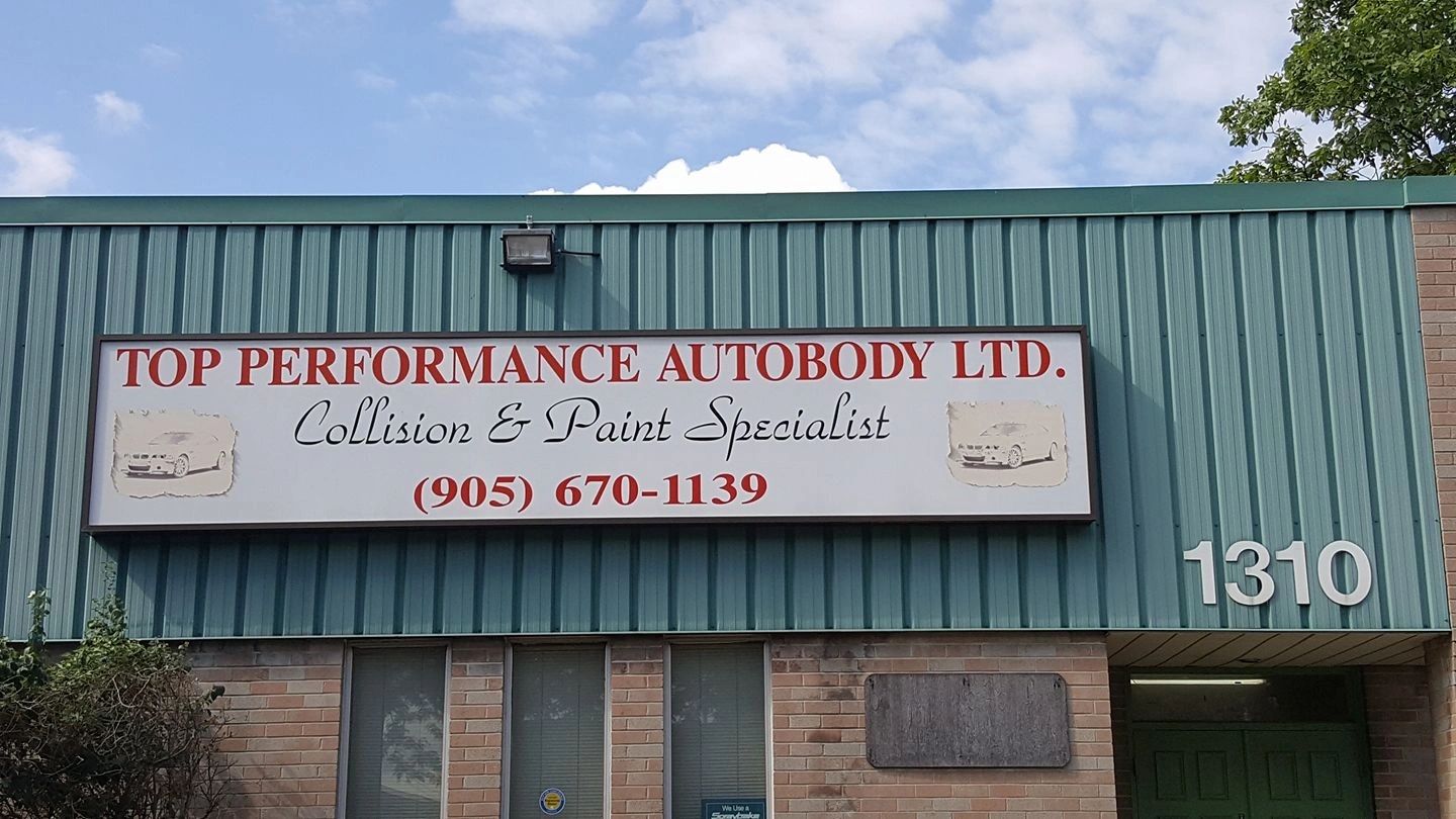 The hand-painted Top Performance Autobody storefront sign at 1310 Britannia Road East, Mississauga